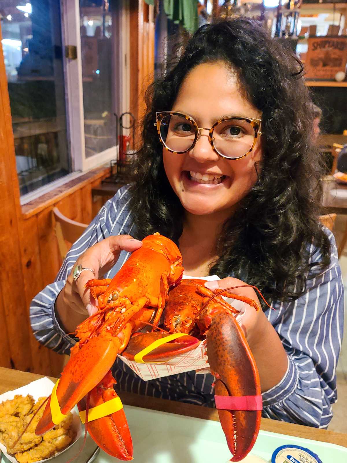 Holding a whole steamed lobster in Maine